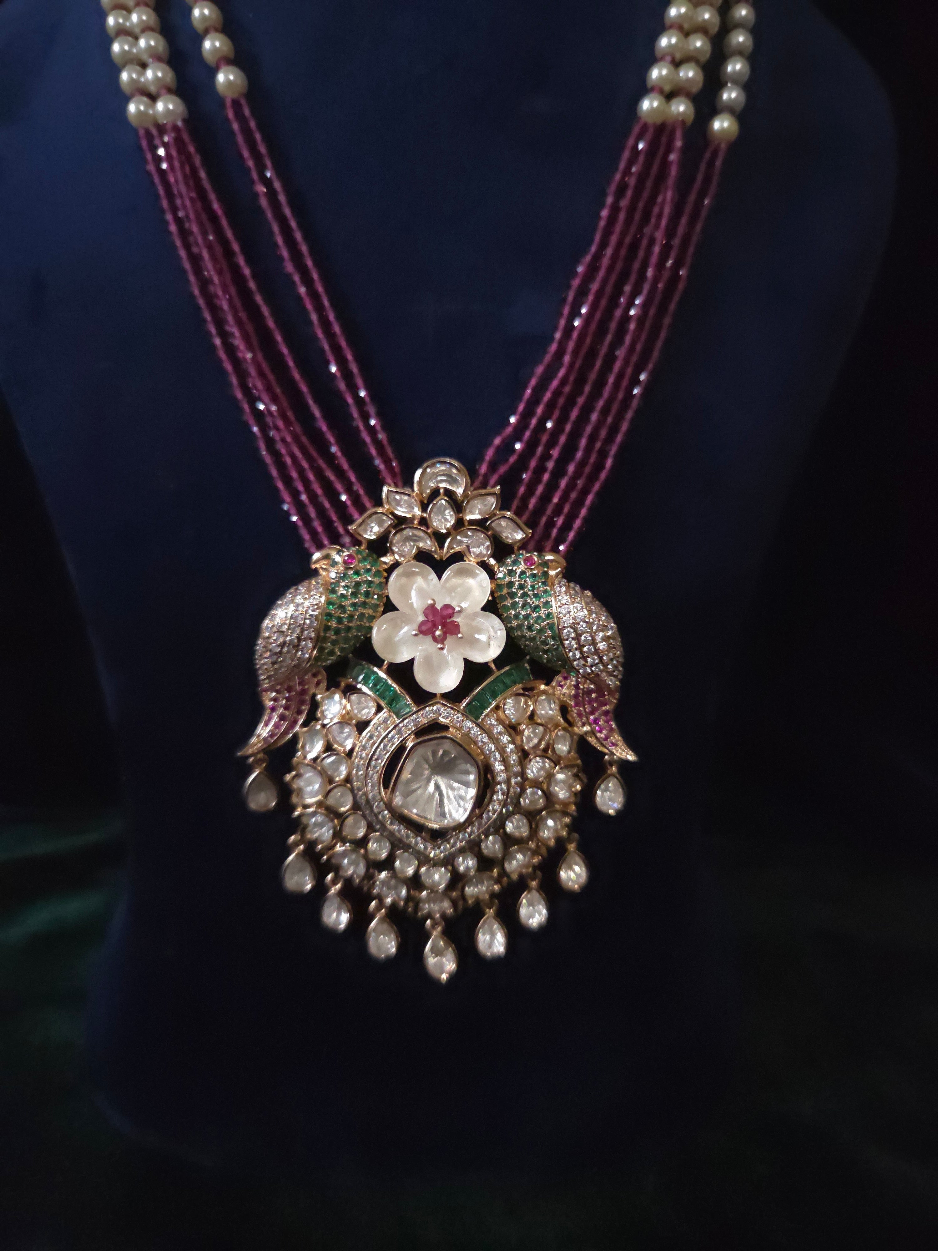 Detail shot of Tota-e-Ishq Polki parrot pendant with emerald and ruby accents – Mithudi by Zirca Luxe