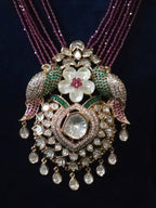 Detail shot of Tota-e-Ishq Polki parrot pendant with emerald and ruby accents – Mithudi by Zirca Luxe