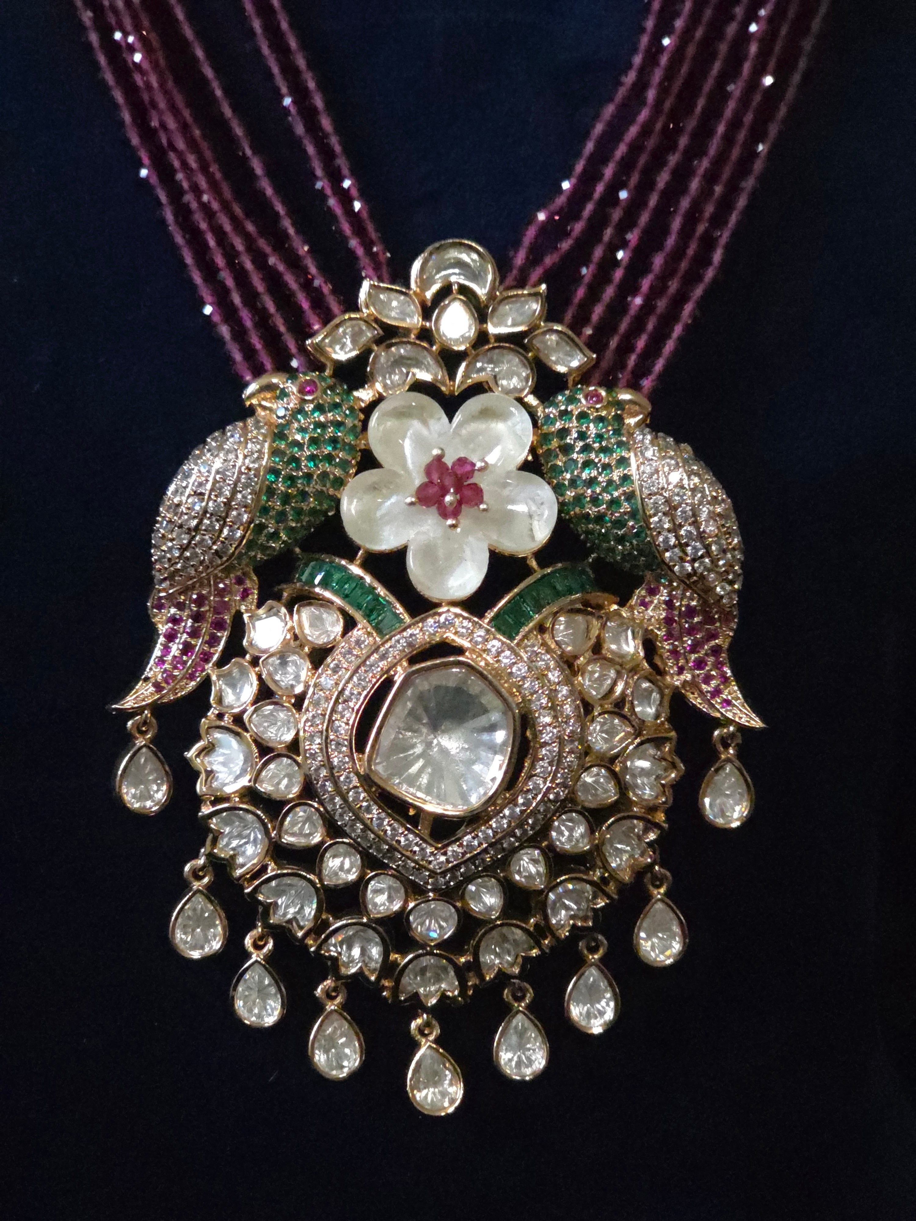 Detail shot of Tota-e-Ishq Polki parrot pendant with emerald and ruby accents – Mithudi by Zirca Luxe