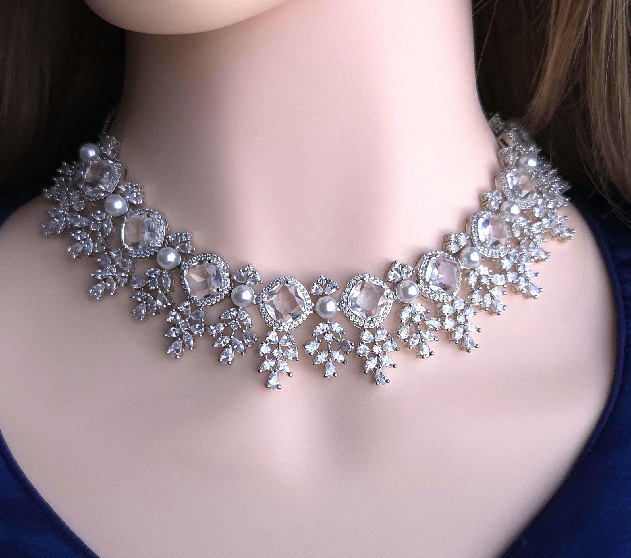 Polished silver tone cluster crystal string with pearl terminals group