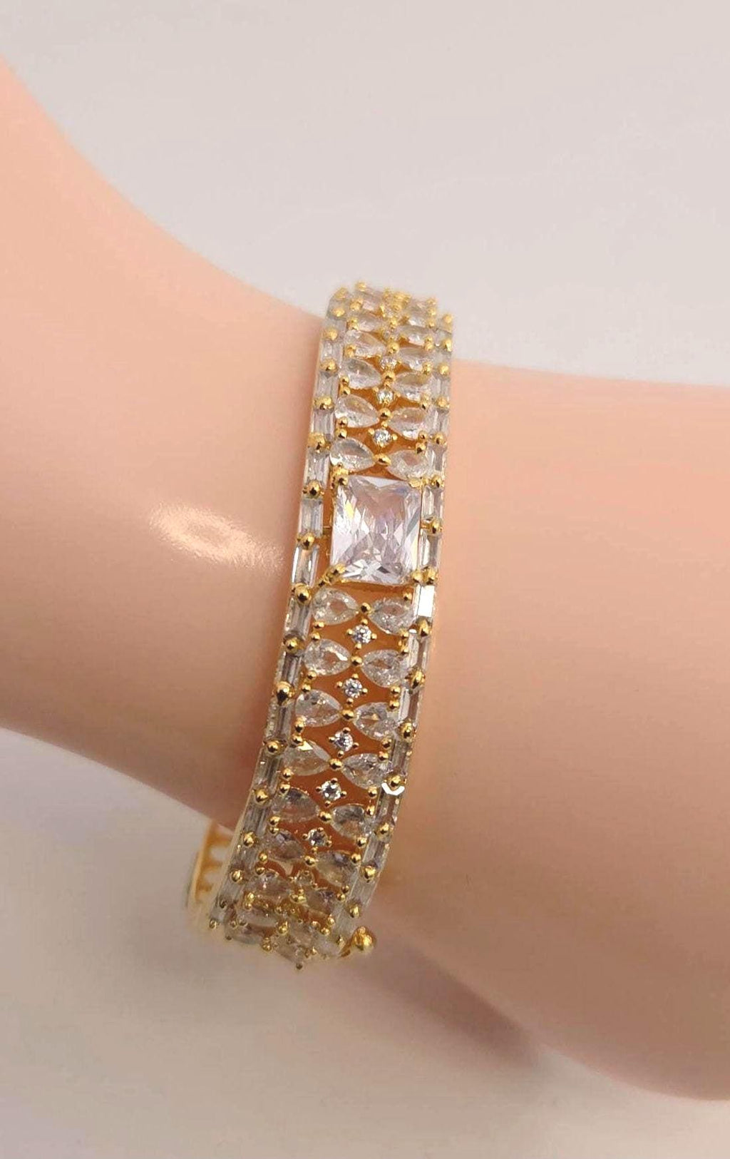 Solid gold overlay openable mechanism emerald cut center gem bangle