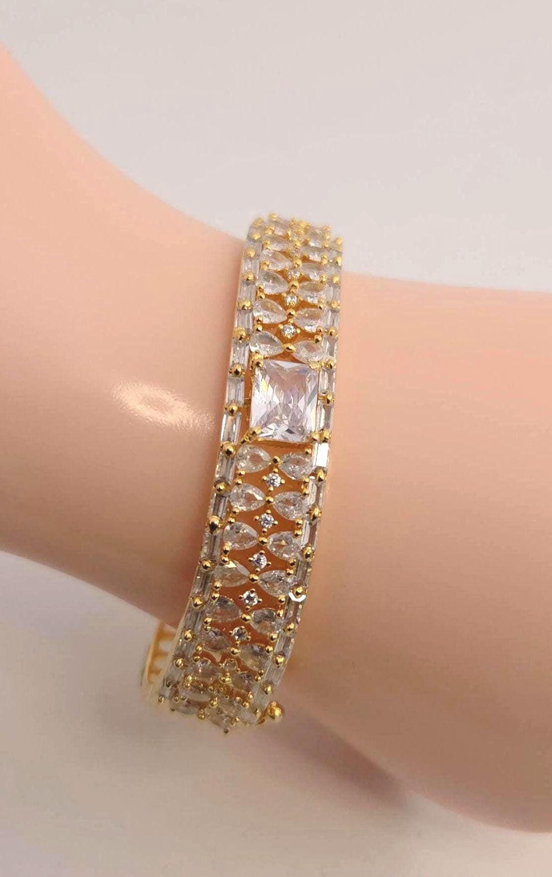 Solid gold overlay openable mechanism emerald cut center gem bangle
