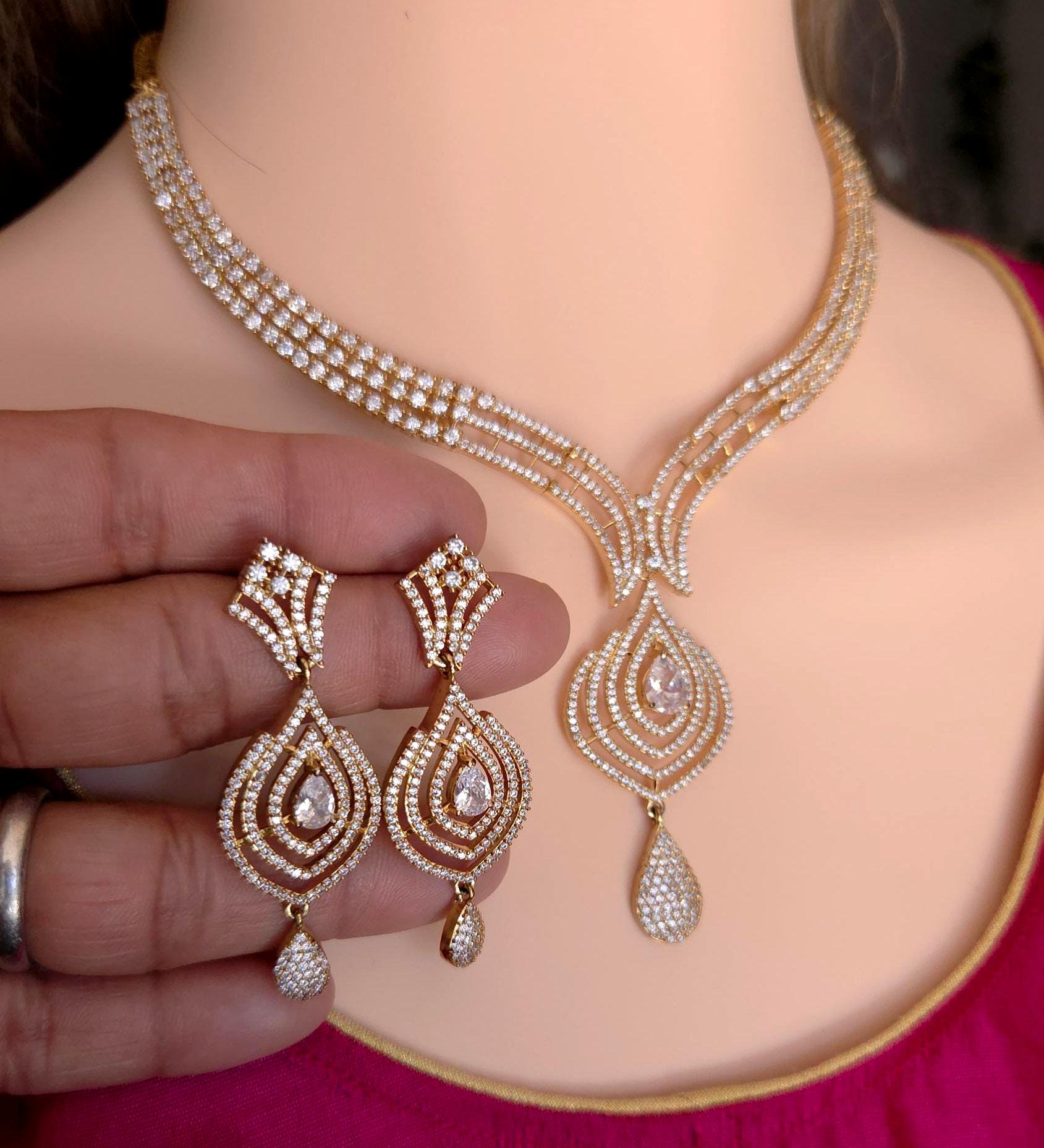 Handheld showcase photo detail delicate layered golden V drop chain