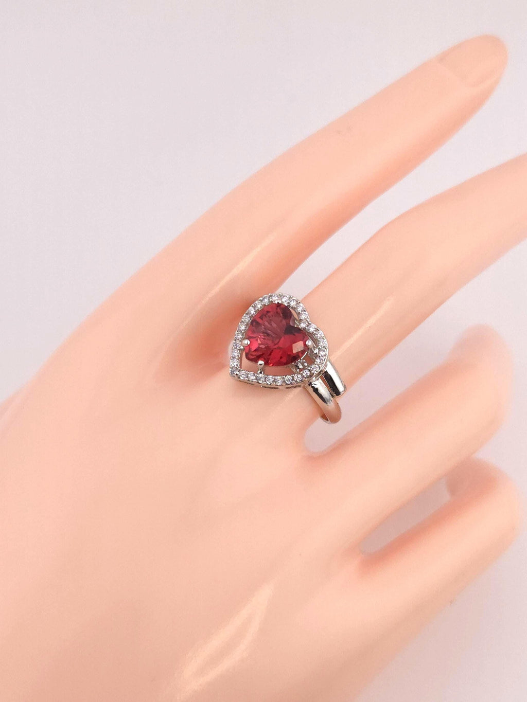 Polished sterling silver band with red heart shaped zircon setting unit