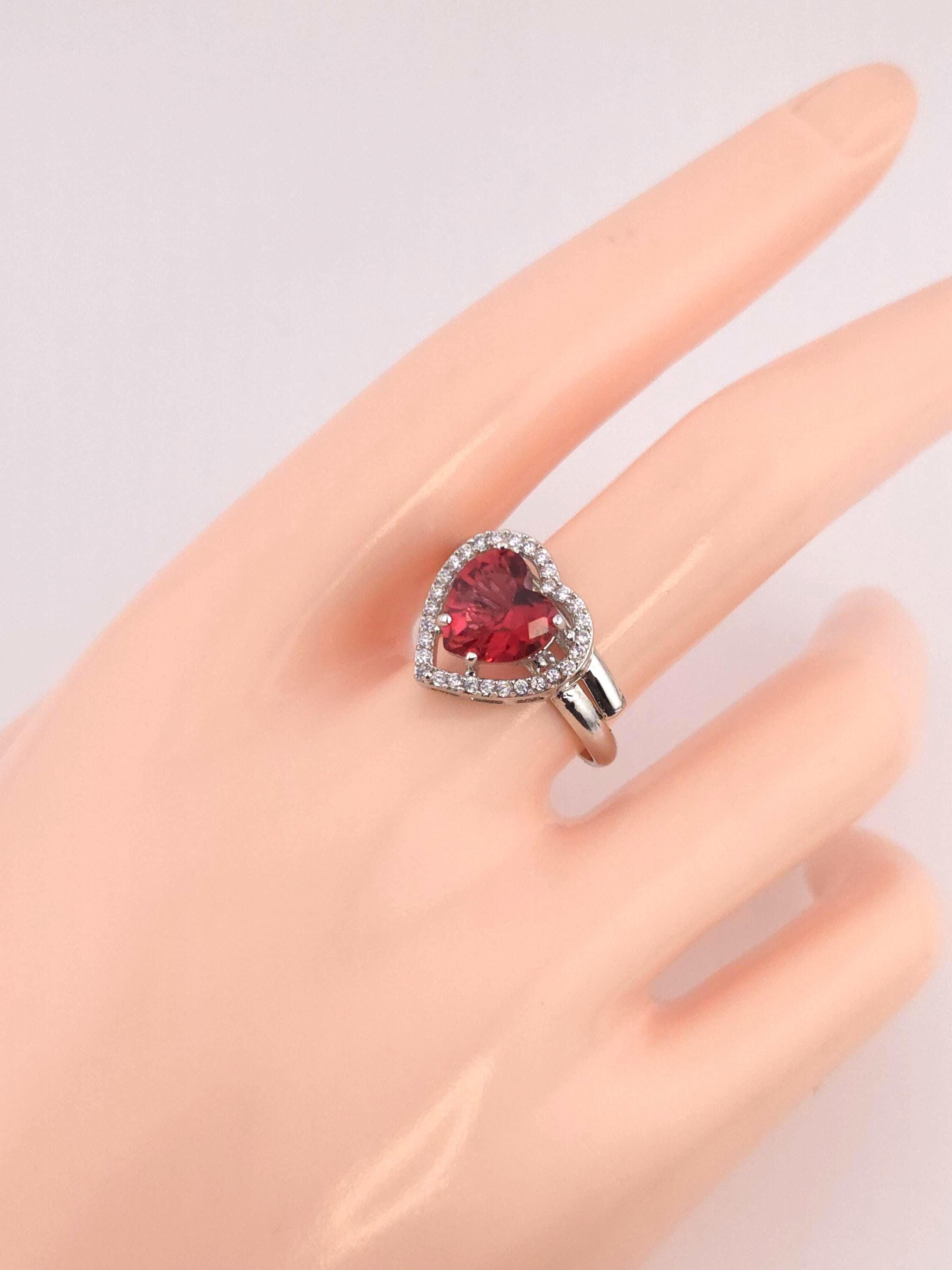 Polished sterling silver band with red heart shaped zircon setting unit