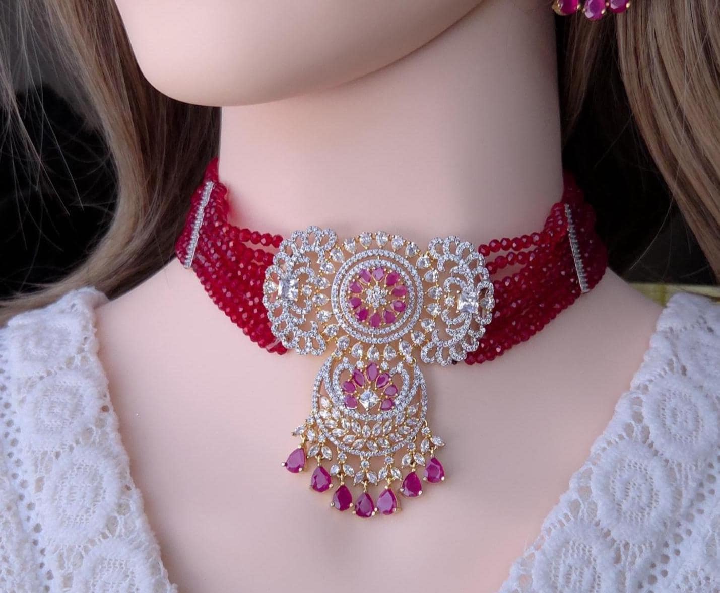Traditional pink bead strings mixed with shining American Diamond choker layout