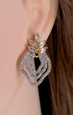 Elegant earring worn on a model's ear with a neutral background