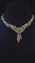 CZ Floral Garden Twin Bloom Necklace & Feather Drop Earring Set Gulnara – twin emerald green and pink CZ floral medallions with white CZ pavé vine-leaf chain and cascading feather drop in rose gold finish