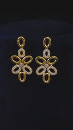 Modern gold-plated CZ oval-link necklace and matching drop earrings shown in an elegant jewelry styling vide