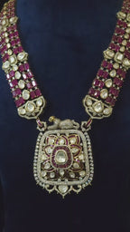 Ruby & Polki CZ Multi-Strand Long Pendant Necklace & Drop Earring Set Shaahi – ruby bead multi-strand chain with polki CZ stations, lotus mandala cushion pendant with panther motif clasp, and matching tiered drop earrings in gold finish