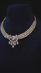  Nooraya triple 18K gold-plated, premium-quality CZ leaf necklace with matching floral drop earrings styled on a model.