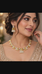 Jaalika geometric CZ lattice necklace with matching trapezoid drop earrings in a triple micro 18K gold-plated finish, styled for weddings and formalwear.