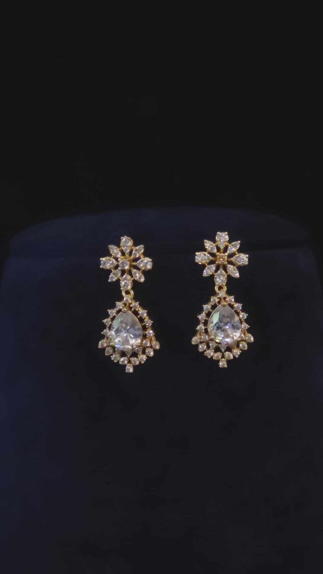 Vanya gold-plated floral teardrop CZ necklace and matching drop earrings in a jewelry styling video