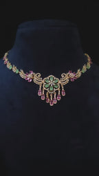 Emerald & Pink CZ Floral Medallion Necklace & Chandelier Earring Set Zainab – emerald green CZ floral medallion with cascading pink CZ teardrop drops, scrollwork vine chain, and rose gold finish