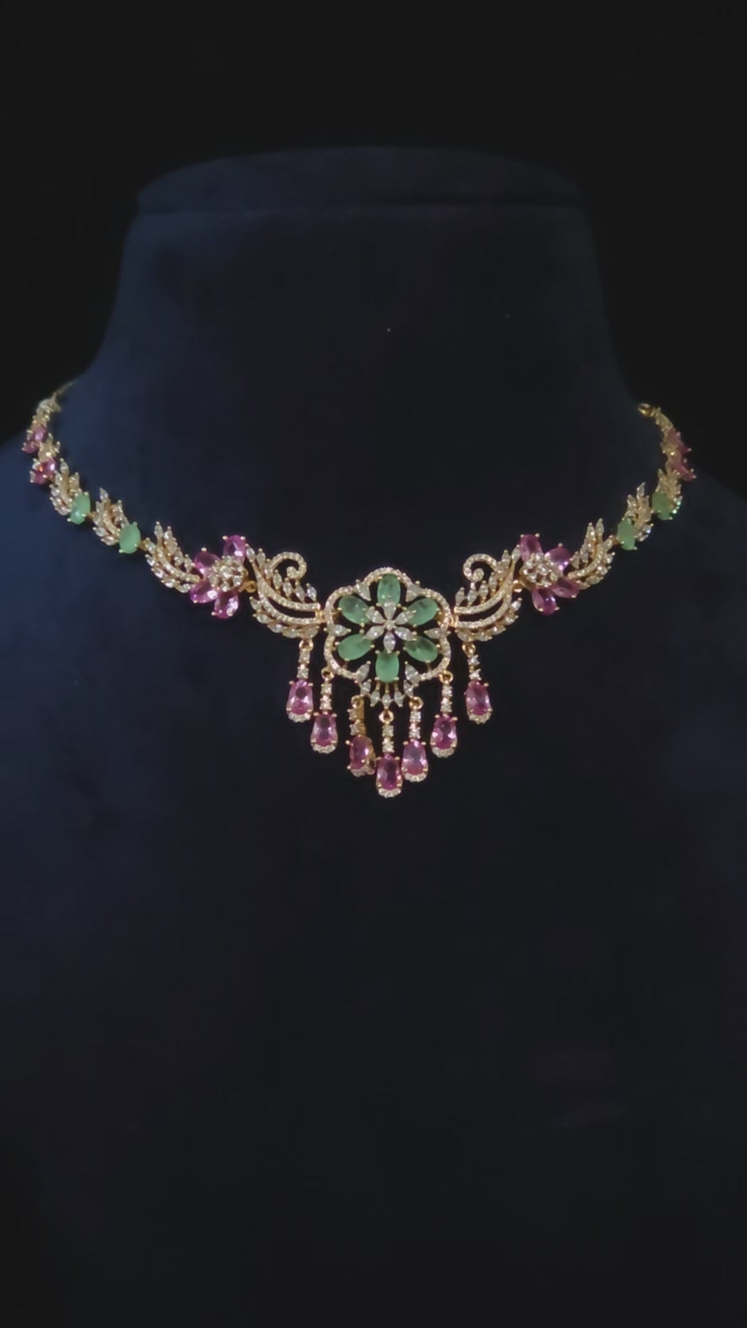 Emerald & Pink CZ Floral Medallion Necklace & Chandelier Earring Set Zainab – emerald green CZ floral medallion with cascading pink CZ teardrop drops, scrollwork vine chain, and rose gold finish