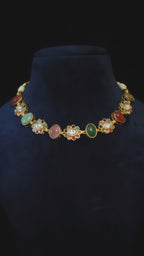 Navratna Kundan Floral Cabochon Choker & Earring Set Kamala – multicolor gemstone bridal choker necklace with polki CZ flower links, jade teardrop earrings, and antique gold finish