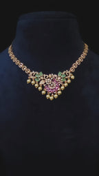 Pink & Emerald CZ Floral Pearl Drop Necklace & Earring Set Priya – pink marquise CZ floral pendant with emerald green CZ leaves, white CZ scrollwork chain, and cascading pearl drops in rose gold finish