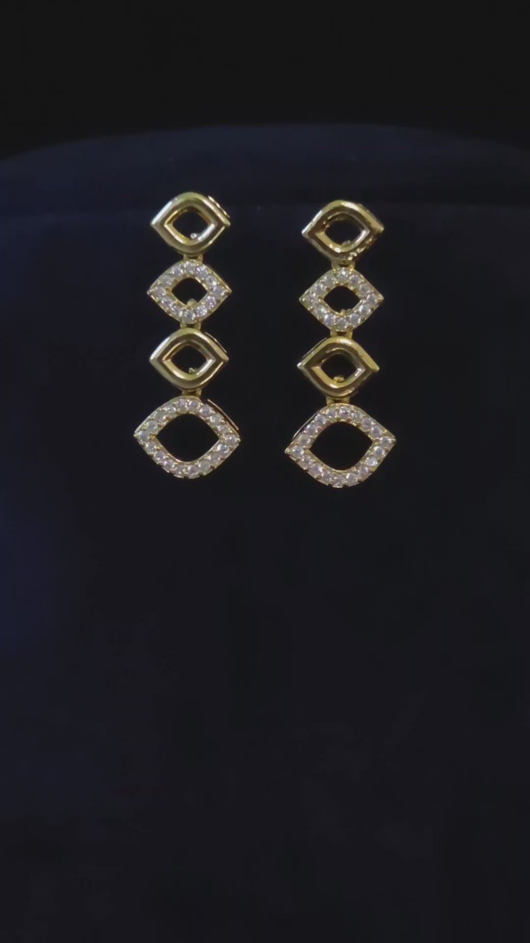 Gold-plated geometric CZ link necklace and matching drop earrings shown in an elegant jewelry styling video