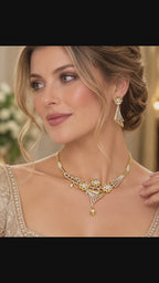 Gold-plated CZ floral fan necklace and matching fan-shaped drop earrings shown in an elegant jewelry