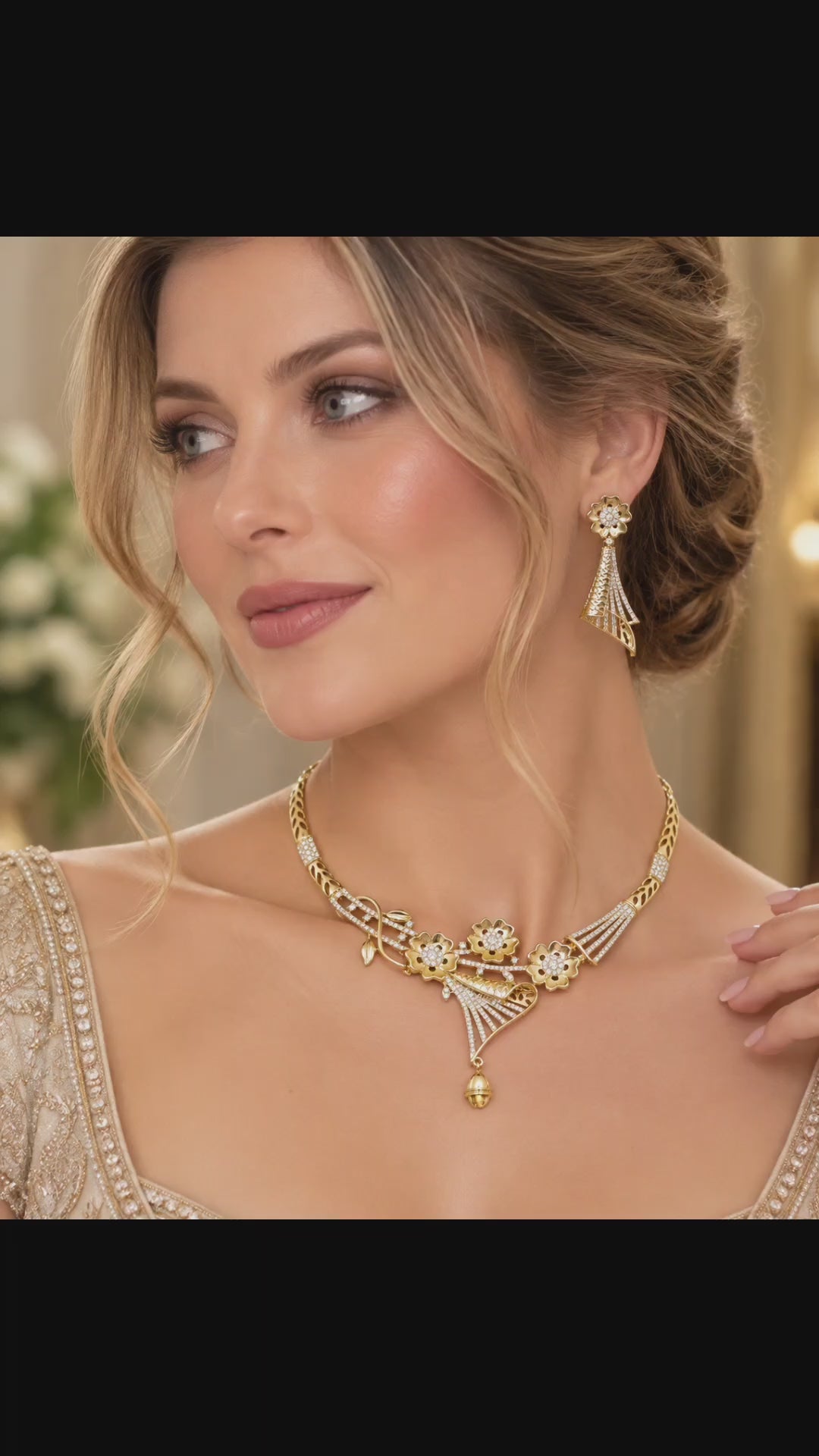 Gold-plated CZ floral fan necklace and matching fan-shaped drop earrings shown in an elegant jewelry