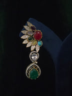 Close-up of a multicolor gemstone leaf drop earring with emerald accent