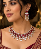 1.	Woman wearing a gold-plated ruby CZ bridal choker and matching chandelier drop earrings
