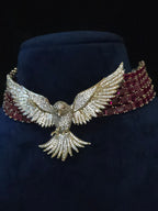 Ruby CZ collar necklace with pave bird pendant displayed on a mannequin bust