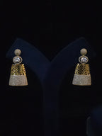 A pair of gold and silver-toned statement earrings displayed on a black velvet jewelry stand. Each earring features a round crystal-studded top, a textured gold middle section, and a silver crystal-encrusted lower section.