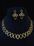 Gold-tone jewelry set featuring a matching necklace and earrings with oval links, displayed on a black velvet mannequin bust.