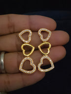 A gold heart-link earrings  displayed features alternating solid gold heart links and open heart links paved with small clear stones.