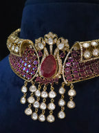 Detailed view of the bridal choker’s teardrop center, wine-red stones, clear accents, and cascading embellishments
