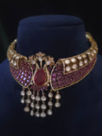 Side view of the wine-red bridal choker necklace showing its clear-stone accents and cascading drops.