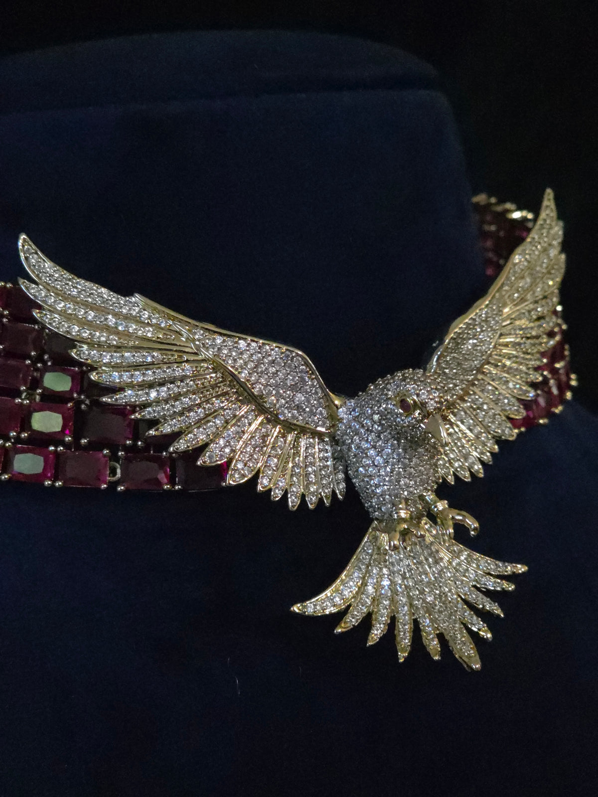 9.	Close-up of ruby CZ collar necklace and chandelier earrings styling detail