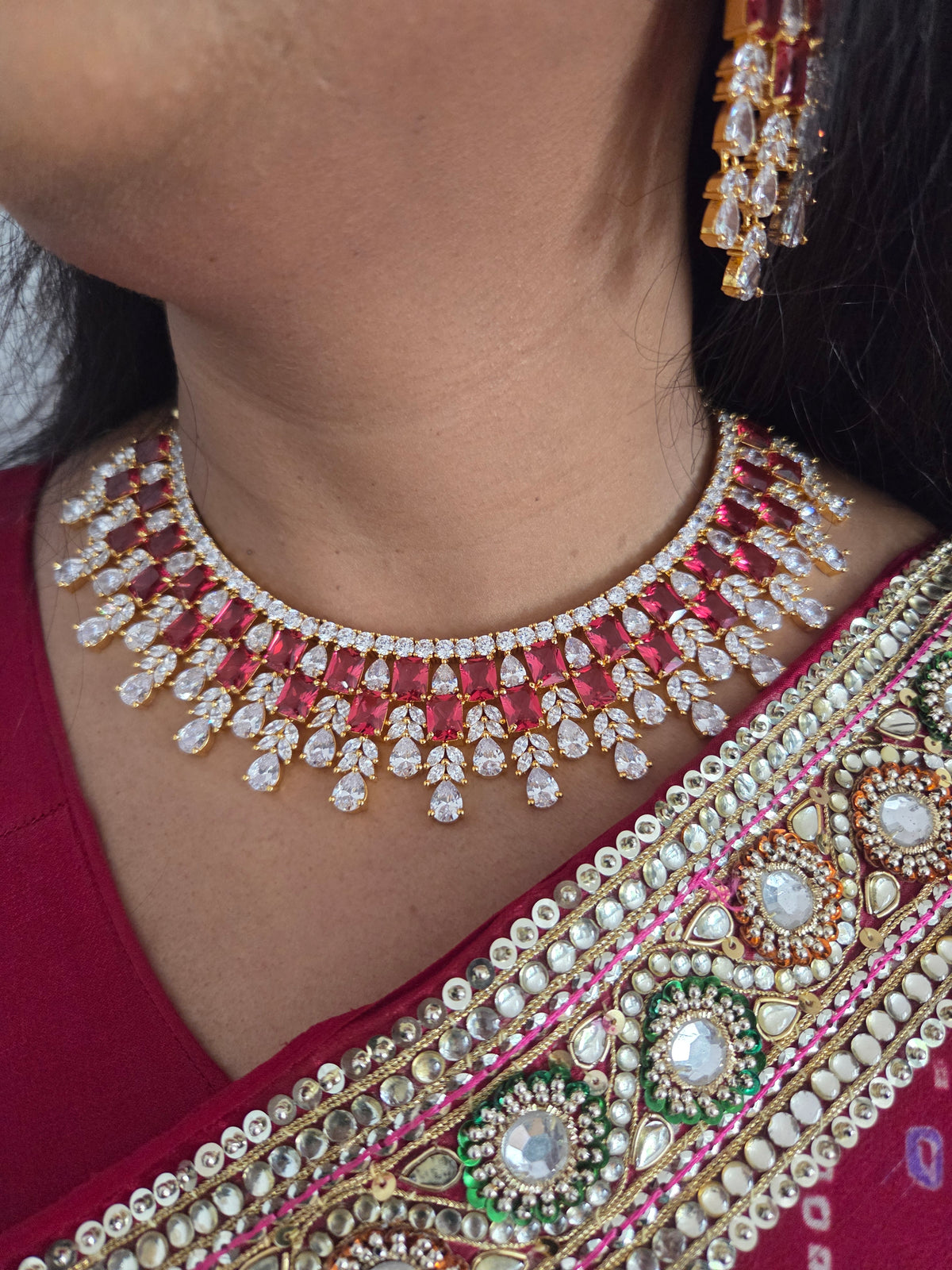 Close-up of a model wearing the gold-plated ruby CZ bridal choker and matching chandelier earring