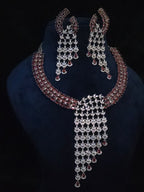 Front view of the Riva statement necklace with burgundy-toned stones and cascading clear CZ details
