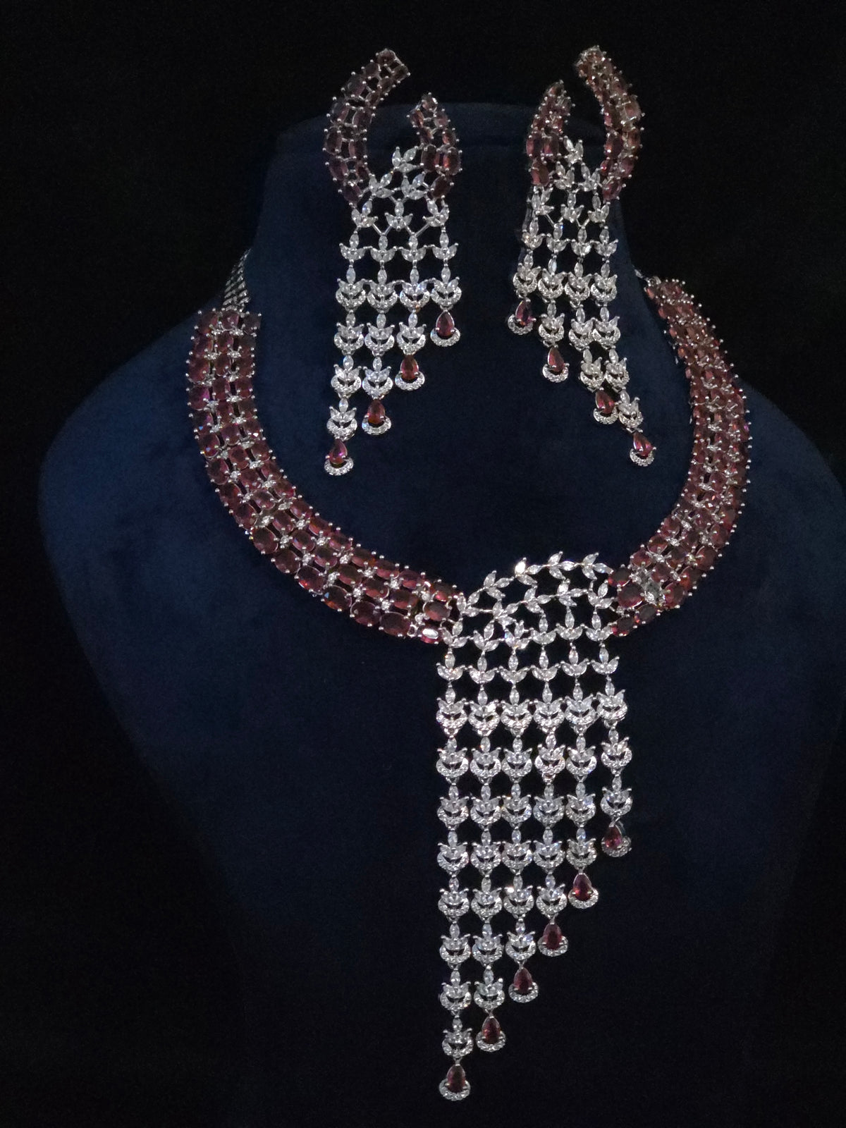 Front view of the Riva statement necklace with burgundy-toned stones and cascading clear CZ details