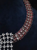 Close-up of the necklace’s burgundy-toned stones and clear CZ cascade.