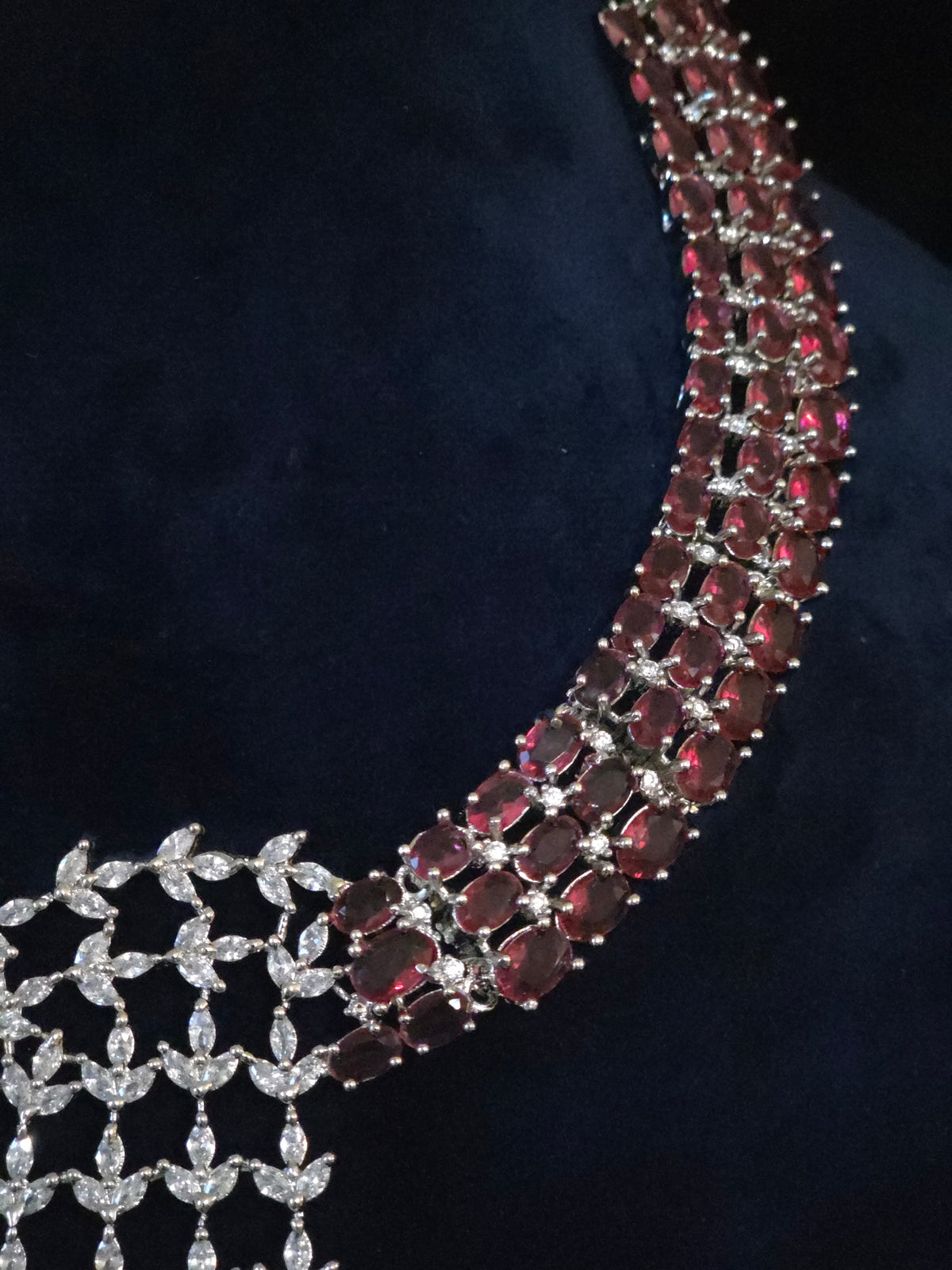 Close-up of the necklace’s burgundy-toned stones and clear CZ cascade.