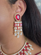 Close-up of a model wearing a gold-plated ruby CZ chandelier earring
