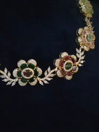Close-up of Gulbahar gold-plated floral CZ necklace with green, red, pink, and mint accents
