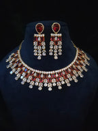 Gold-plated ruby CZ bridal choker and matching chandelier earrings displayed together